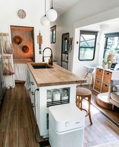 a kitchen with an island in the middle and lots of counter space on the other side