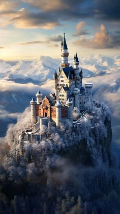 an aerial view of a castle in the middle of some mountains with snow on it