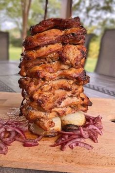 a stack of food sitting on top of a wooden cutting board