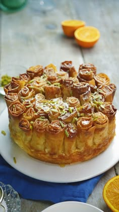 a cake on a plate with orange slices around it