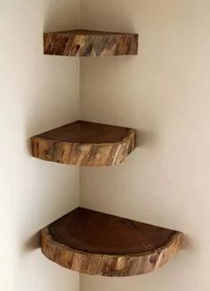 three wooden shelves in the corner of a room