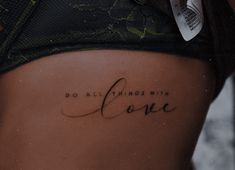 a woman's stomach with the words do all things with love written on it