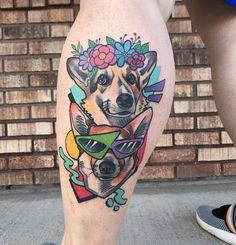 a dog with sunglasses and flowers on his leg