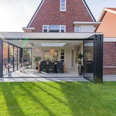 an open patio with sliding glass doors leading to the back yard and dining room area