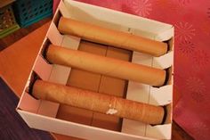 an open box with four different types of breads in it sitting on a table