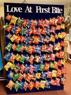 a large display of love at first bite candies in front of a sign that says love at first bite