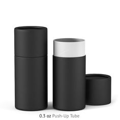 three black and white cylindrical containers with lids