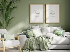 a living room with green walls and two framed pictures on the wall next to a white couch