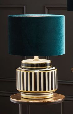 a black and white striped lamp sitting on top of a table