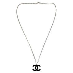 An iconic Vintage Chanel CC Logo Necklace from the 2006 Spring collection. Elevate your look with this classic from the House. Vintage Condition: Very good without damage or noteworthy wear. Signed: Chanel, 2006 Materials: rhodium plated metal, enamel Fastening: lobster clasp Approximate Dimensions: 43.5cm, pendant 2cm Established in 2016, this is a British brand that is already making a name for itself in the jewellery world both at home and internationally. My business has been built with love Chanel Logo Necklace, Luxury Round Channel Set Necklaces, Cross Stitch Necklace, Logo Necklace, Chanel Necklace, House Vintage, Chanel Logo, Logo Vintage, Chanel Vintage