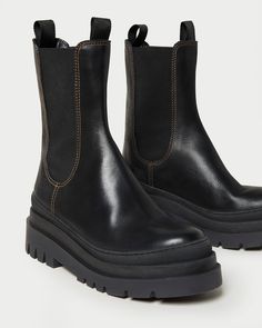 Tall, chunky, lug sole boot in black soft calf leather. Features a padded insole and rounded toe. Pulls on. 2.25 inch heel. Aw23 Fashion, Chunky Boots Outfit, Lug Boots, Rooney Mara, Fall Lookbook, Lug Sole Boots, Tall Leather Boots, Chelsea Boots Men, Loeffler Randall