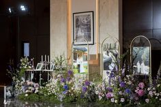 flowers and pictures are on display in front of a building