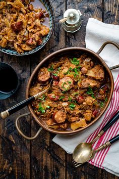 a bowl filled with food next to another bowl full of food on top of a wooden table