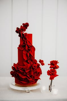 a red wedding cake with ruffles on it