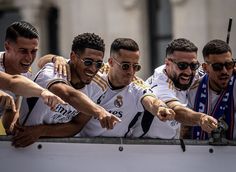 several men in soccer uniforms pointing at something