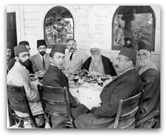 a group of men sitting around a dinner table