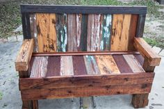 a wooden bench sitting on top of a sidewalk