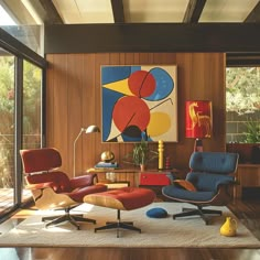 an image of a living room setting with chairs and paintings on the wall in it