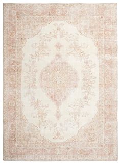 an antique rug with pink and white colors