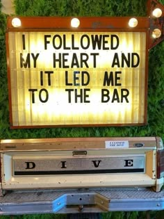 a lighted sign that says i followed my heart and it led me to the bar