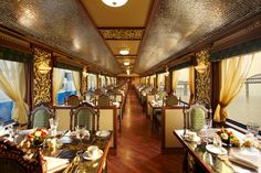 a dining car on a train with tables and chairs set up for two people to eat