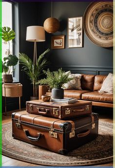 three pieces of luggage sitting on top of a rug in front of a couch and coffee table