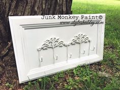 the trunk of a tree has been painted white and is next to some paint samples