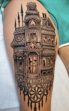 a woman's thigh with a drawing of a house on the back of her leg