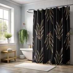 a bathroom with a black shower curtain and gold leaf print on it, along with a white bathtub