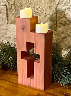 a wooden block with two candles in it