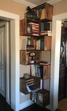 the bookshelf is made out of wooden crates