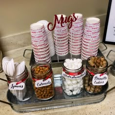 a tray filled with lots of food on top of a counter next to a sign