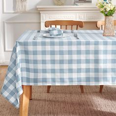 a blue and white checkered tablecloth on a dining room table