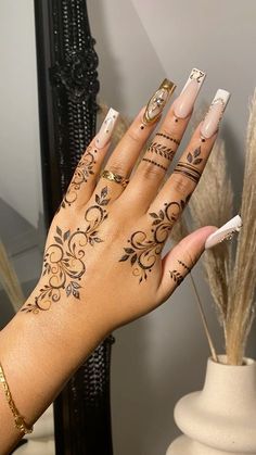 a woman's hand with tattoos on it