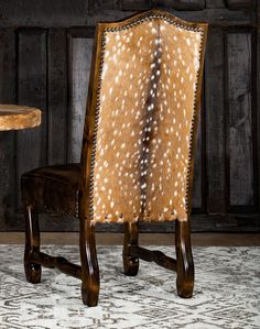 the back of a chair with deer hide upholstered on it's sides