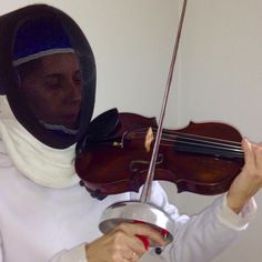 a woman wearing a veil and holding a violin