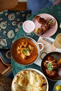 a table topped with plates and bowls filled with food