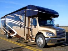 an rv is parked on the side of the road with its awning down and it's door open