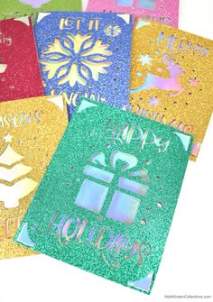 six different colored cards with the words happy holidays written on them in gold, green, blue, and red