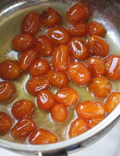 tomatoes are being cooked in oil in a pot on the stove top, ready to be cooked