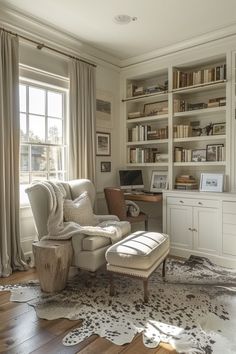 a living room filled with furniture and bookshelves next to a window covered in cow hide rugs