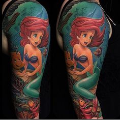 the little mermaid is sitting on top of her stomach and holding onto an orange fish