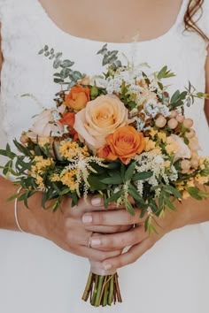 a woman holding a bouquet of flowers in her hands