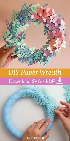 the paper wreath is being made with blue and pink flowers, while someone holds it in their hands