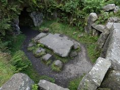 an aerial view of some rocks in the middle of a grassy area with trees and bushes