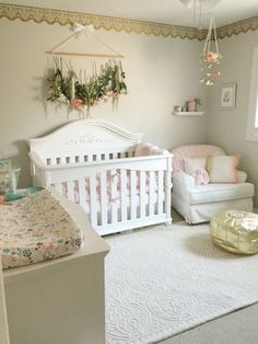 a baby's room with two cribs, a chair and a bed