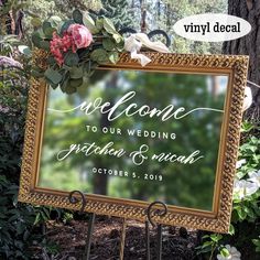 a wedding welcome sign with flowers on it