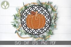 an orange pumpkin on a black and white circle surrounded by greenery with the words svg dxf eps png - dxf