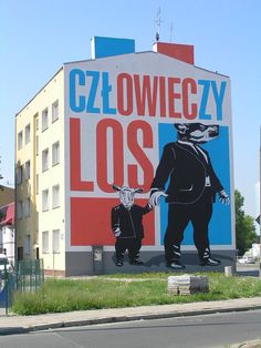 a large mural on the side of a building that says czl owliezy lost