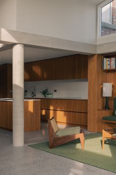 a living room filled with furniture next to a tall wooden book shelf on top of a hard wood floor